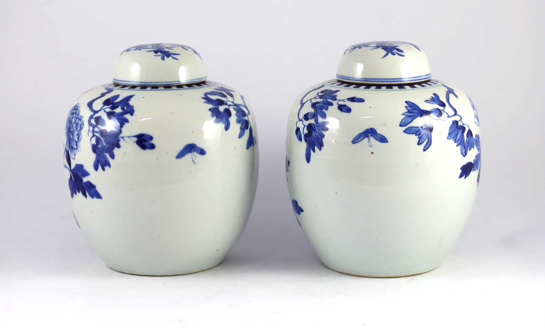 A pair of Chinese blue and white jars and covers, 19th century, 25cm high